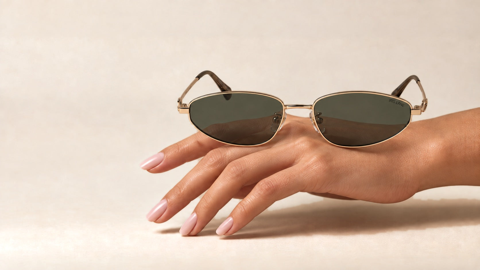 An IRIS LANE metal frame resting on a hand
